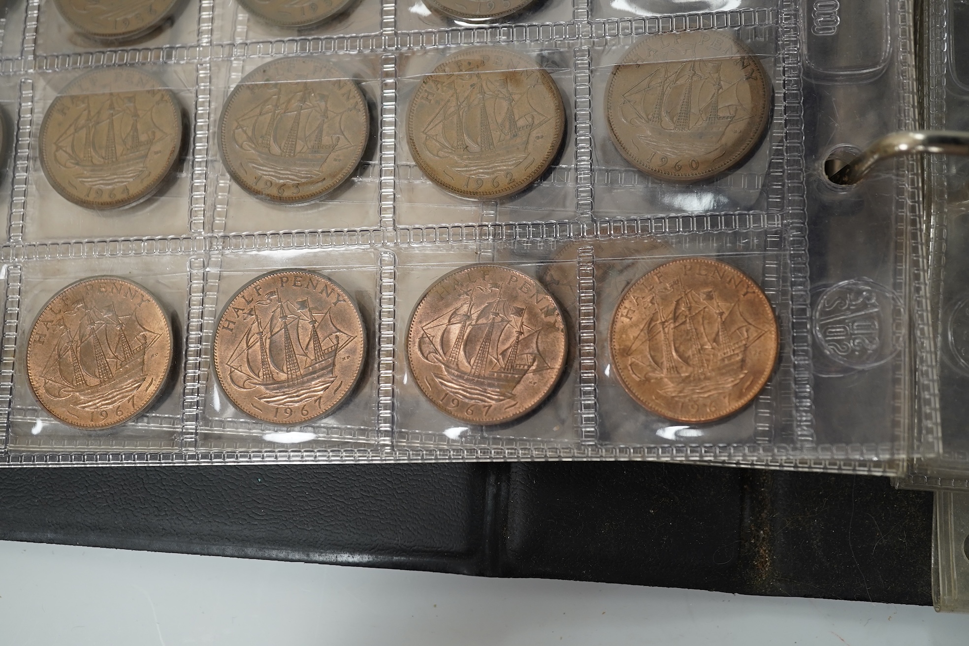 A collection of various coinage in an album, mostly George V to QEII